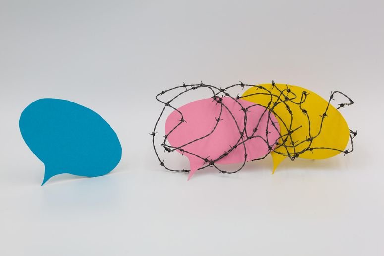 Dos globos de diálogo rodeado por alambre de púas