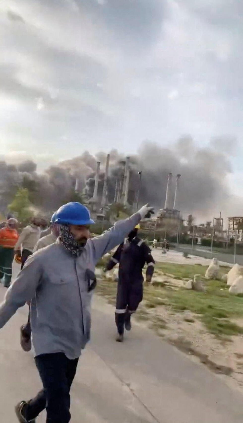 Workers evacuate area around Saudi Aramco's Ras Tanura oil refinery as smoke rises following a reported Iranian drone strike on March 2, 2026